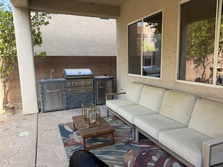 Covered patio with built-in grill and seating